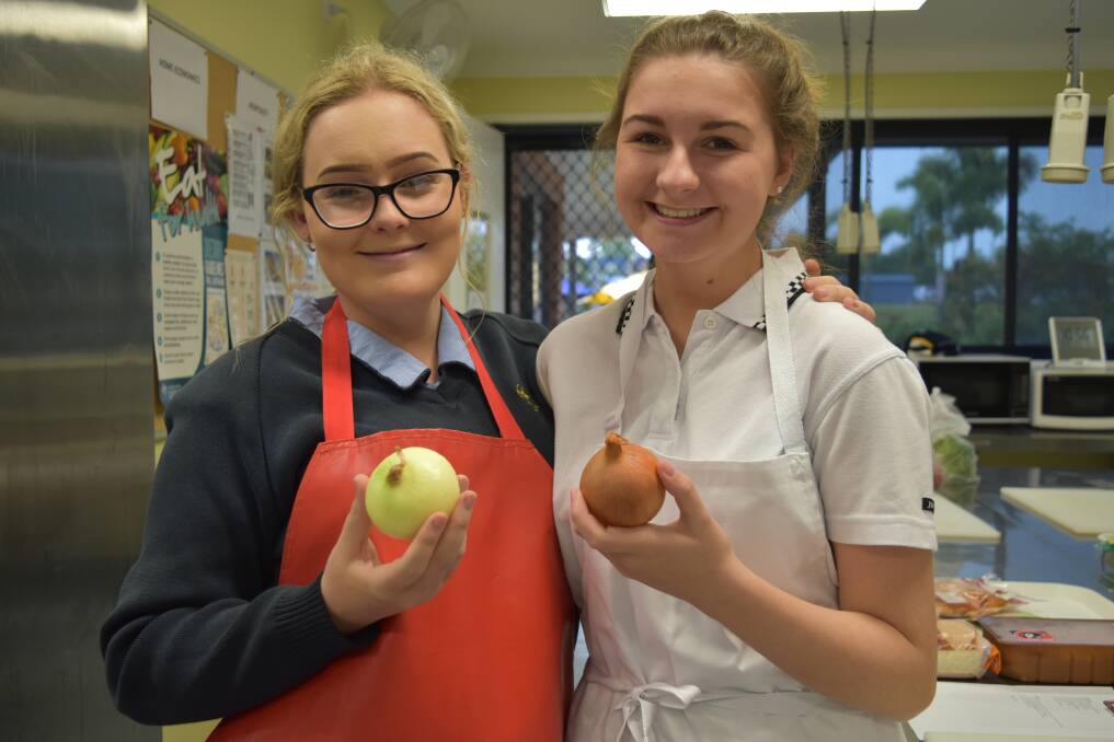 Lily-Bella Nicholson peeled some onions to make navarin of lamb. She is pictured with friend Sophie McKee. Photo: Hannah Baker