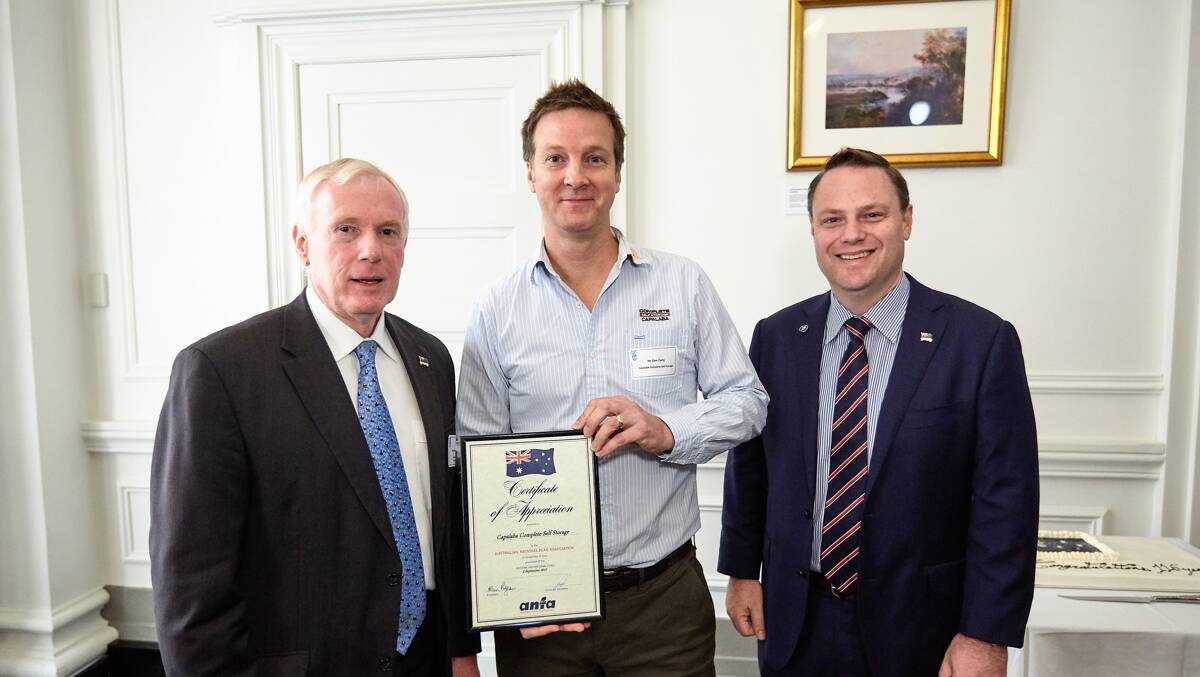 APPRECIATED: Sam Carty accepts a certificate from the president of the Australian National Flag Association Qld Allan Pigeon AM and deputy mayor Adrian Schrinner.
