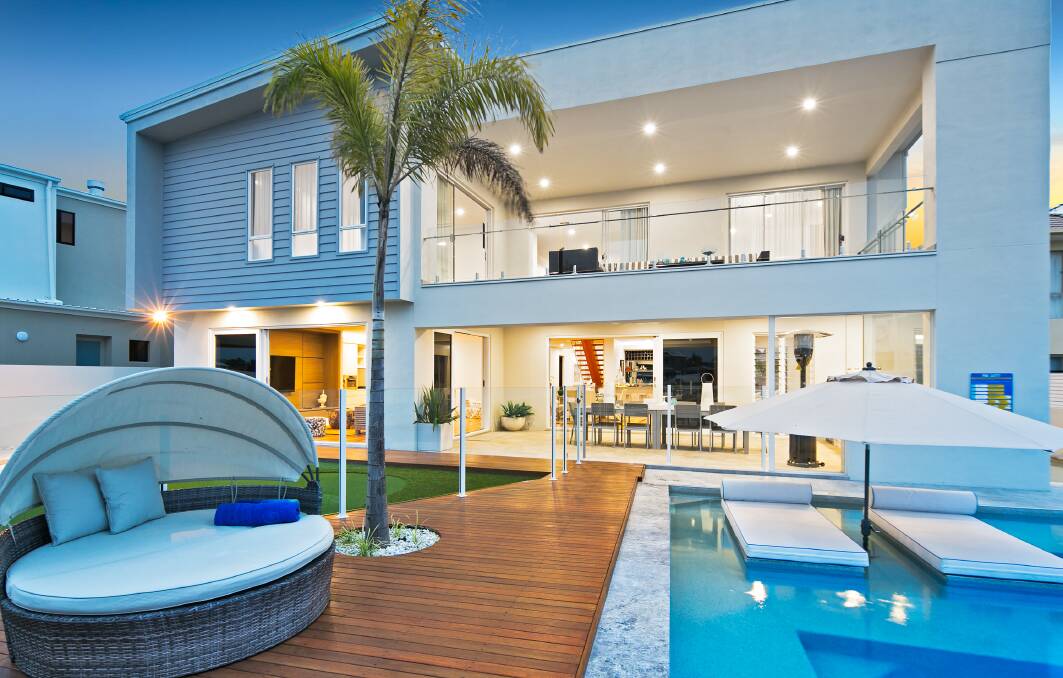 INDULGE: This home oozes luxury - from the clean finishes of the spectacular pool with floating sun lounges to the supermarket-sized panty and bar where you can pour your beer on tap. 