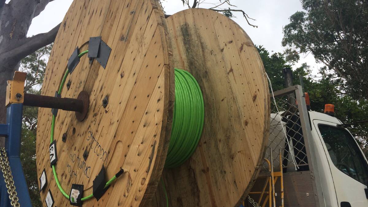 The green fibre cable being rolled out along Double Jump Road at Redland Bay. It is used underground to connect to existing copper pipes. PHOTO: Judith Kerr 