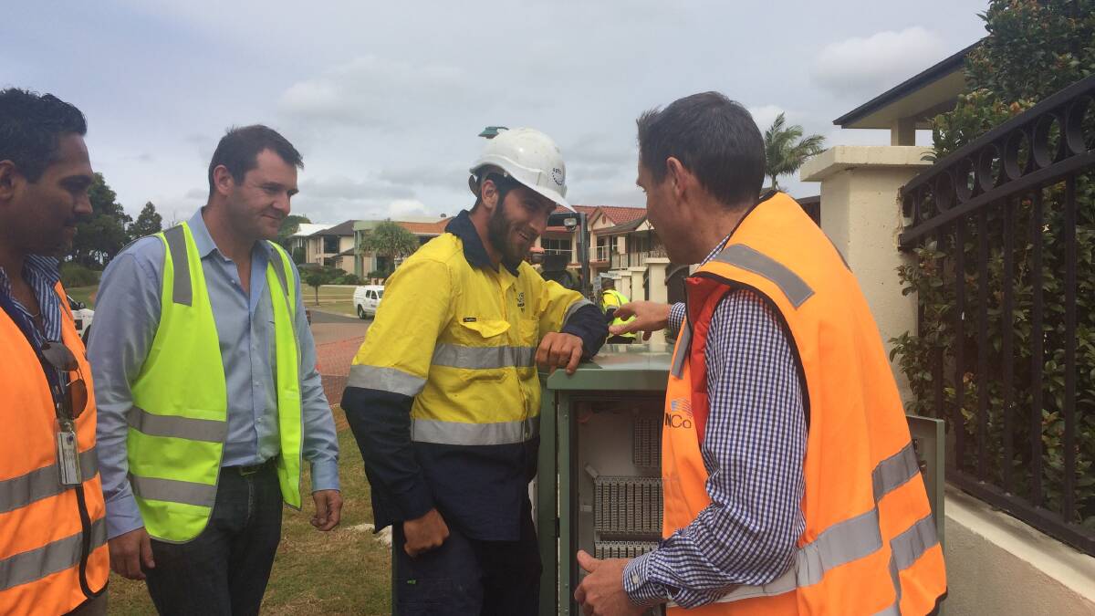 NBNCo project manager for South East Queensland Dinesh Ramen, left, with Downer EDI manager Jonathan Cogan and JSL commercial contractor Reese Hulland show Bowman MP Andrew Laming, right, inside a node box at Cliftonville Place, Redland Bay. PHOTOS: Judith Kerr  