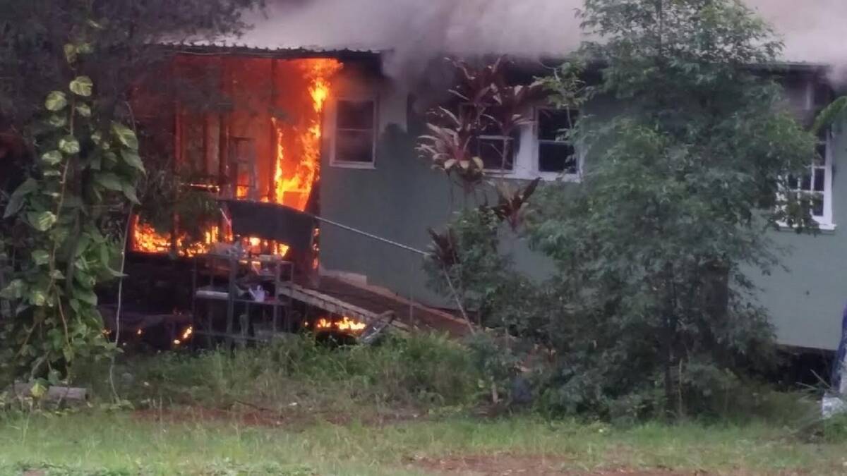 DEVASTATION: The burning house in Fiji Street Russell Island. 