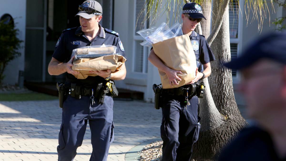 Police remove bags from Ryan McCann's house in September 2014.  