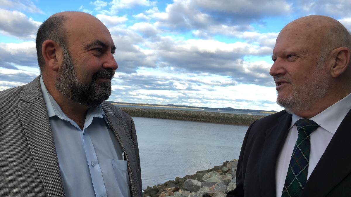 Redland City councillor for the bay islands Mark Edwards speaks to Chamber of Commerce president Colin McInnes at the ferry terminal where CCTV cameras will be installed. Council has railed against the idea. PHOTO: JUDITH KERR