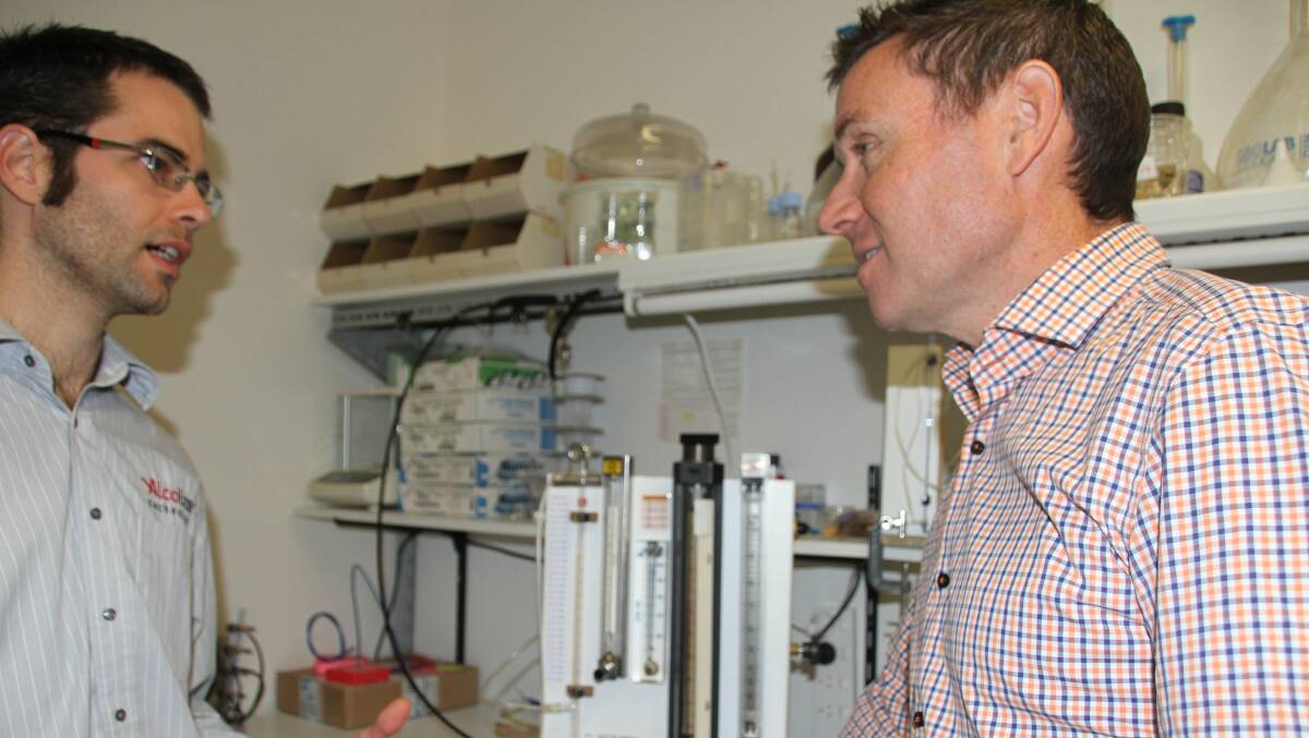 Alcolizer research and development manager James Brown explains the company's high-tech device to Bowman MP Andrew Laming who has promised $4m for more research. PHOTO: Judith Kerr