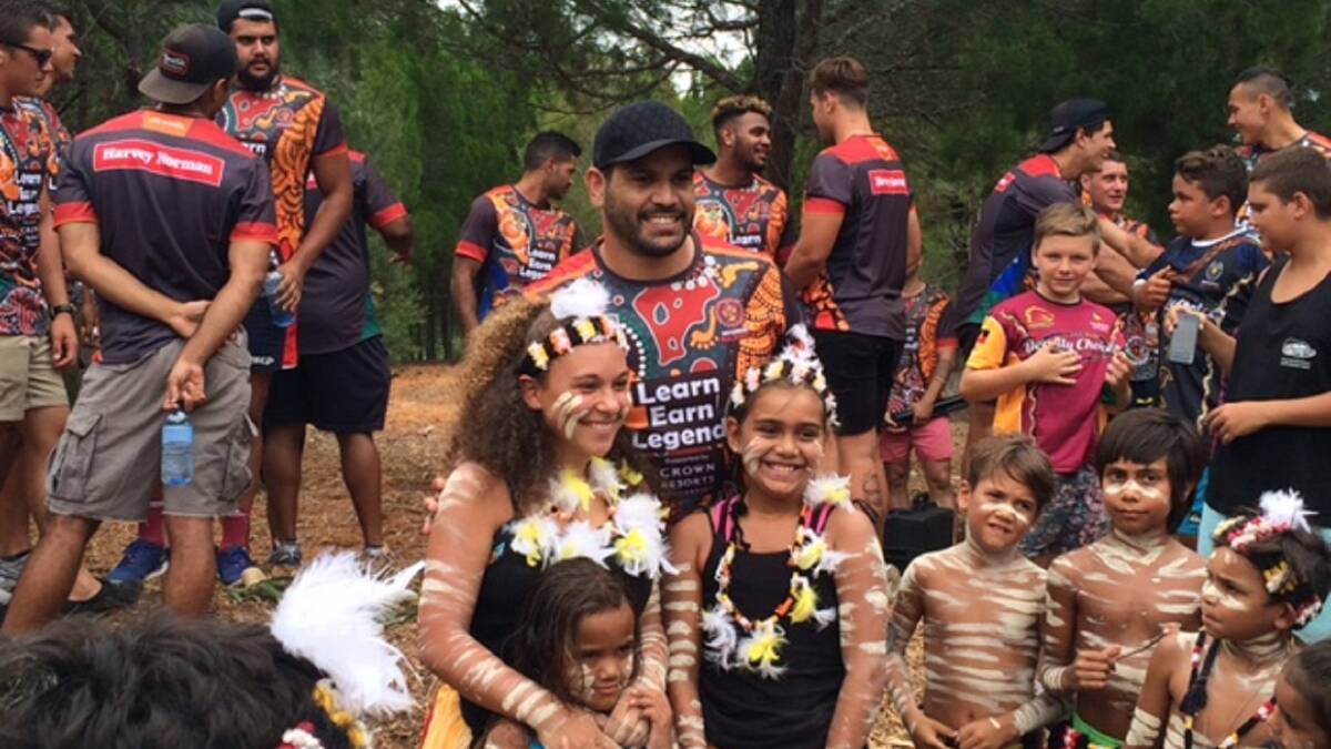 Indigenous All Stars captain Greg Inglis with kids at the two-day Stradbroke Island training match.  