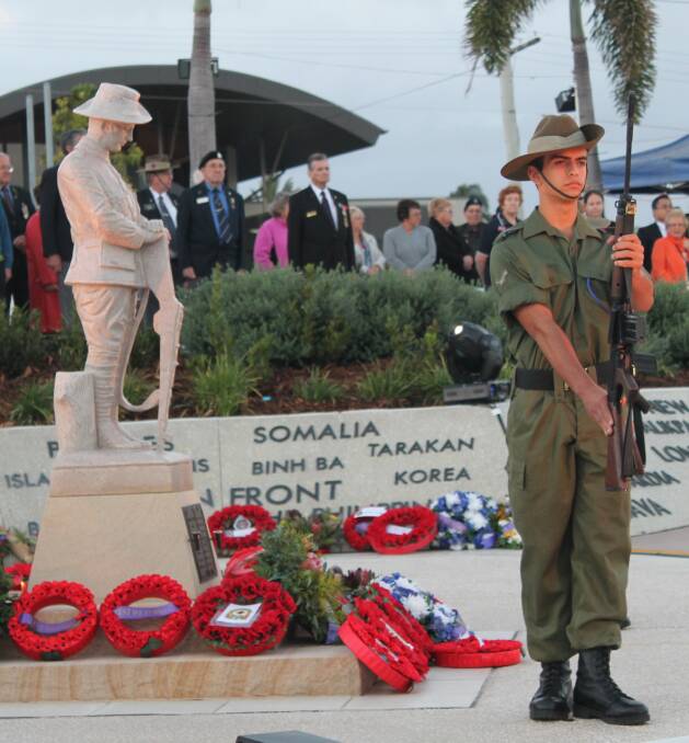 REMEMBERING: Veterans stand at ease and watch over the ceremony while members of the Redlands RSL reenactment group form the catafalque party.  Photos: Lyn Uhlmann 