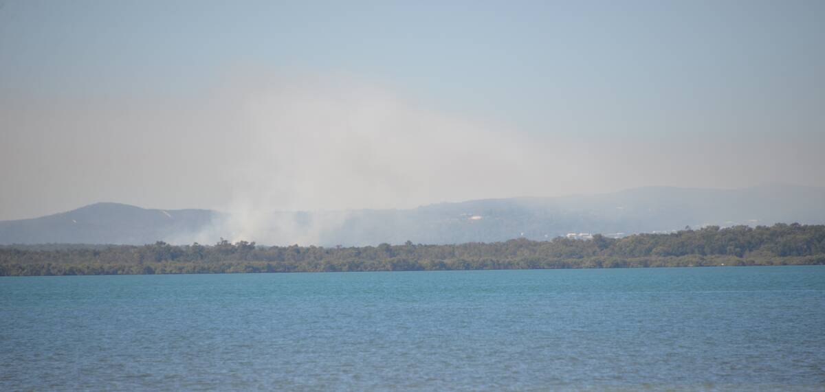 HAZY BAY: The hazard reduction burn gets under way on Peel Island. Burns also are being conducted on nearby Moreton Island to reduce fire risks.