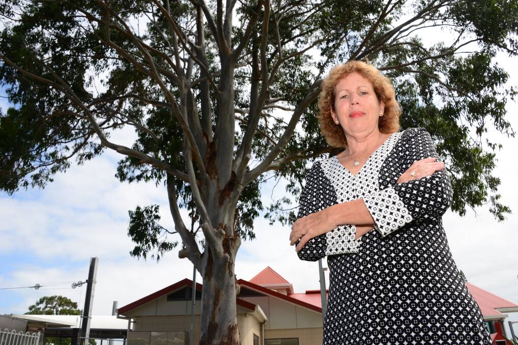 TREE BATTLE: Cr Tracey Huges at the landmark gum tree outside the Cleveland Railway Station.