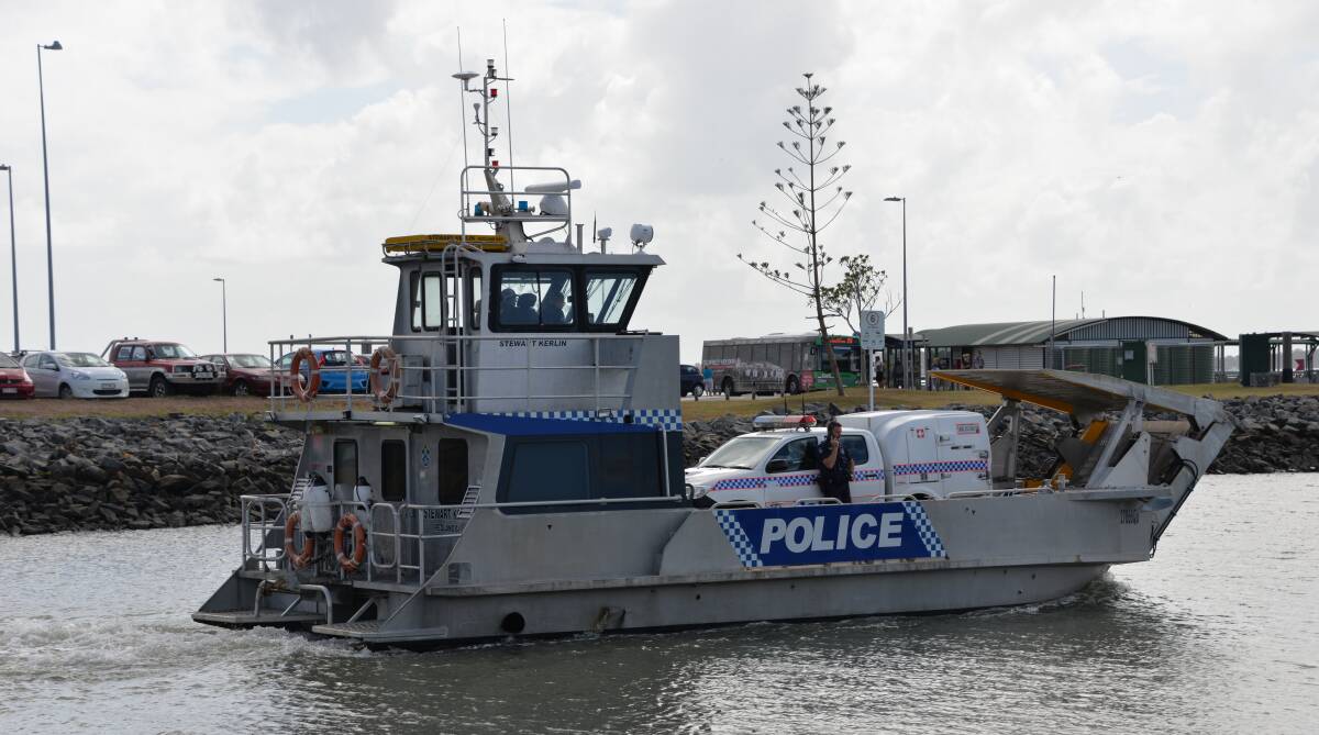 ON PATROL: A police boat leaves its Weinam Creek, Redland Bay, base, complete with 4WD.