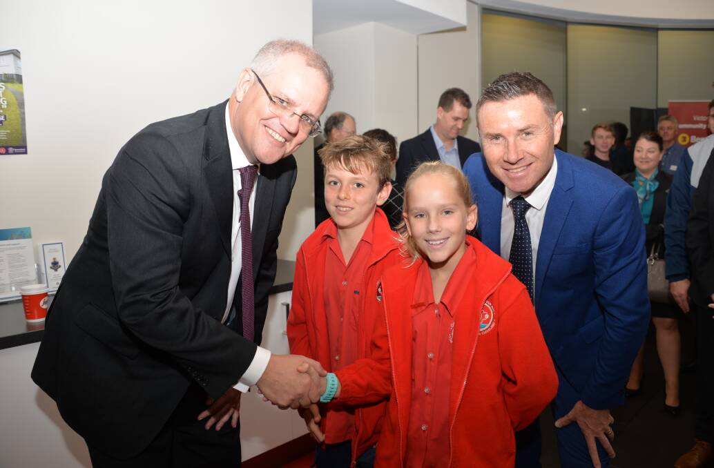 MEET THE LOCALS: Treasurer Scott Morrison meets Cleveland's Star of the Sea Primary School year 6 pupils Kai Langley and Chloe Banks, with Bowman MP Andrew Laming at Star Community Services, Raby Bay. 