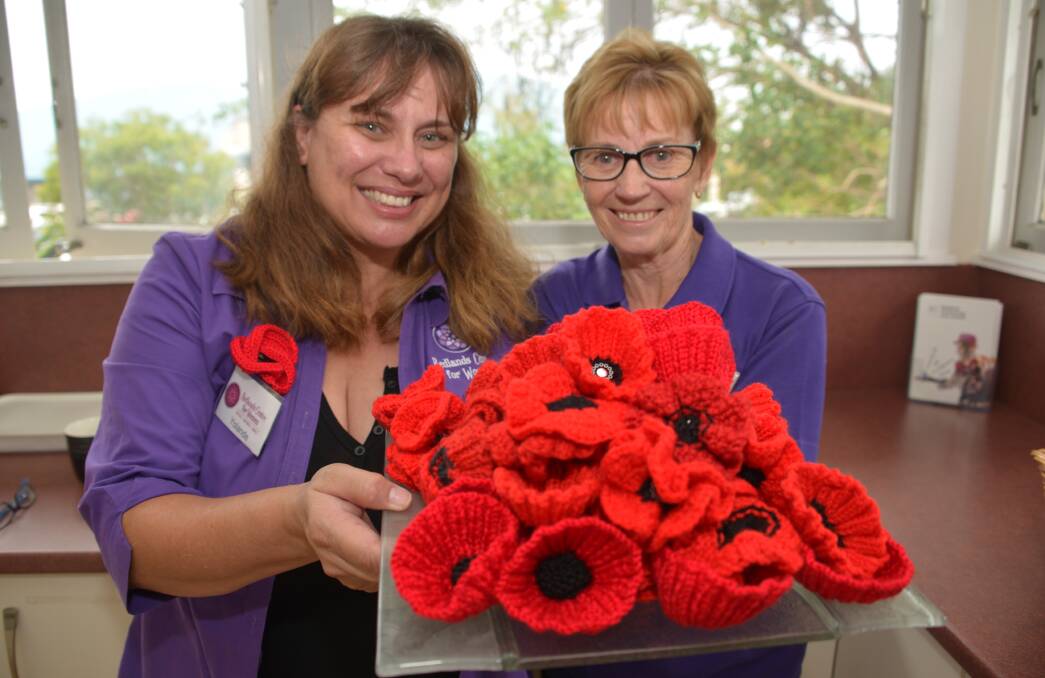 POPPING IN: Women's Centre coordinators Yolande Pannam and Wendy Womersley with a batch of fine red poppies. 