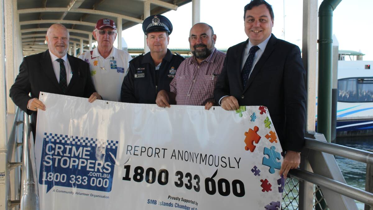 SIGNAGE UP: SMBI Chamber of Commerce president Col McInnes, Crime Stoppers Bayside representative Paul Fitzpatrick, Acting Inspector Mark Norrish, Redland City councillor Mark Edwards and Redlands MP Matt McEachan encourage residents to report suspicious activity earlier this year.