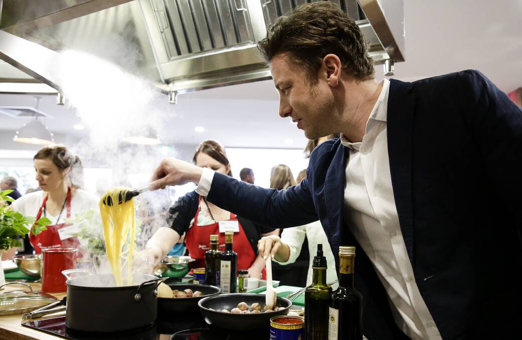 IN THE KITCHEN: Celebrity chef Jamie Oliver ... yep, that's pasta.