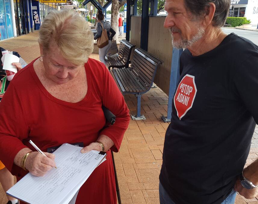 SIGN UP: Petitioners sign on the line.