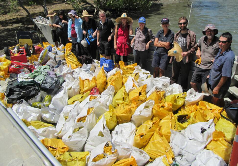 WHAT A LOAD: A Queensland National Parks and Wildlife Service barge loaded with bottles and rubbish dumped at a crabber's hut on Cobby Cobby Island in southern Moreton Bay.