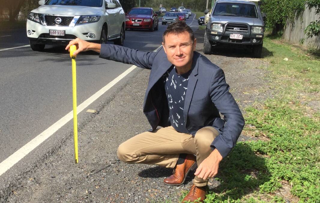 ROAD WORKS: MP Andrew Laming at Rickertt Road where work will be done on a low-lying stretch of road.