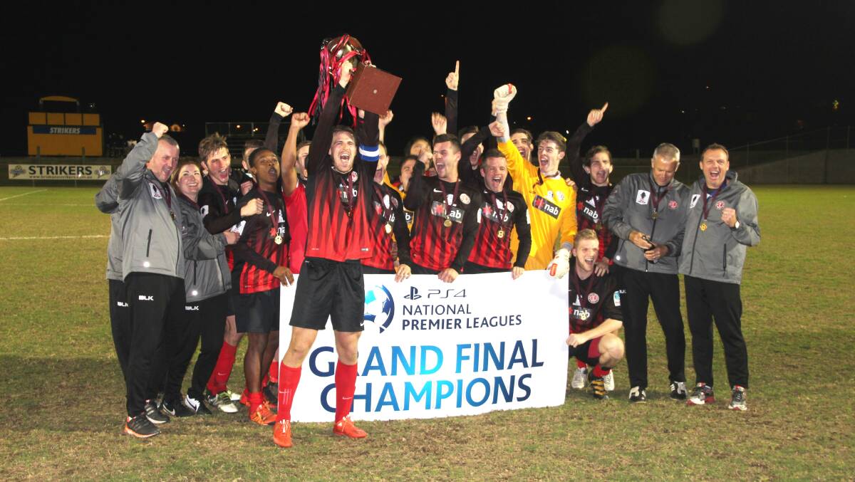 VICTORY: Team members celebrate becoming grand final champions.