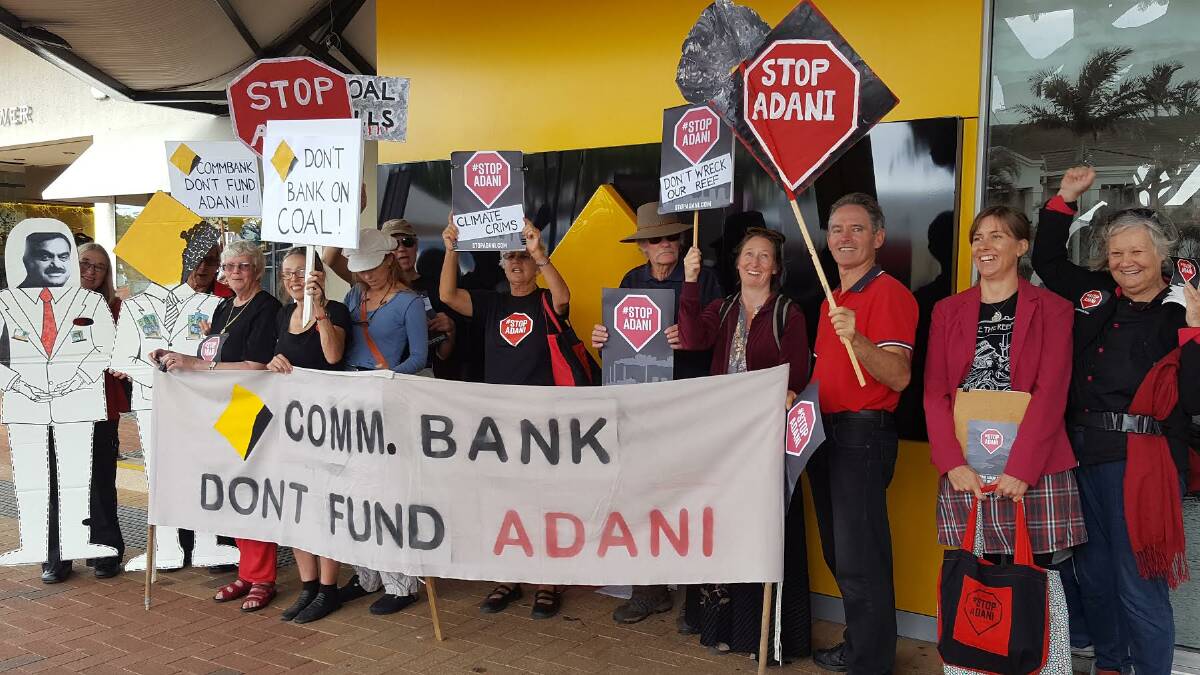 SMBI PROTEST: Islanders line up outside Cleveland's Commonwealth Bank branch as they protest against the proposed Adani coal mine in central Queensland.