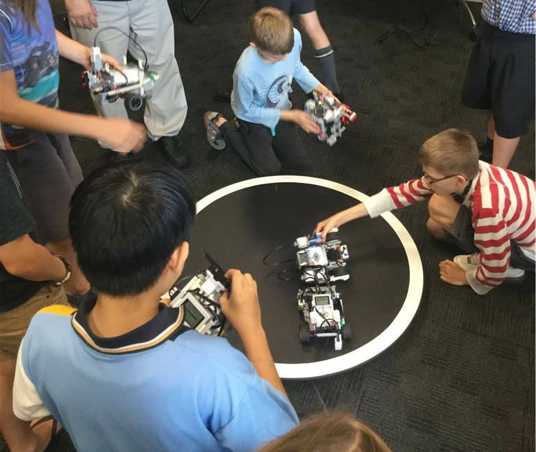 PLAY TIME: Kids get down with some pretty neat robots.