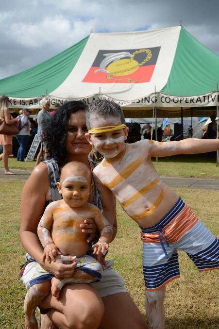 Bre Capell gives River Sartori, 9 months, and Willow Sartori, 5, a cuddle. They are from Kalu Yurung Dancers of the Sunshine Coast.