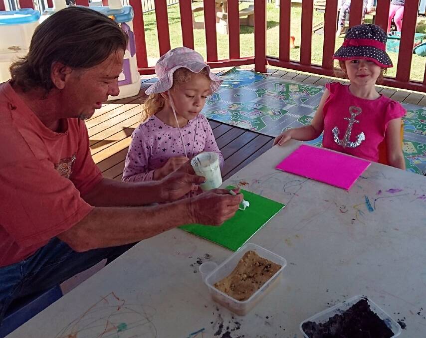 ART LESSONS: Artist Craig Tapp with some young artists.
