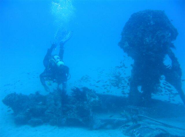 WRECKAGE: RAAF divers at the site of the wrecked DC-3.