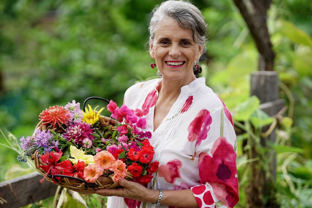 FLOWER POWER: Author Linda Brennan of Capalaba, with a spread of her edible flowers. She has produced a recipe book, focusing on how flowers can add to dishes.  