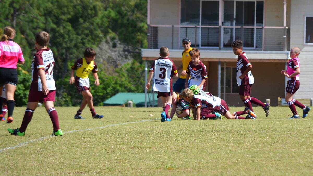 GOOD DEFENCE: The Russell Island Junior Rugby League Stingray U10’s celebrated the Anzac weekend with a game against the visiting Rochedale Tigers.
