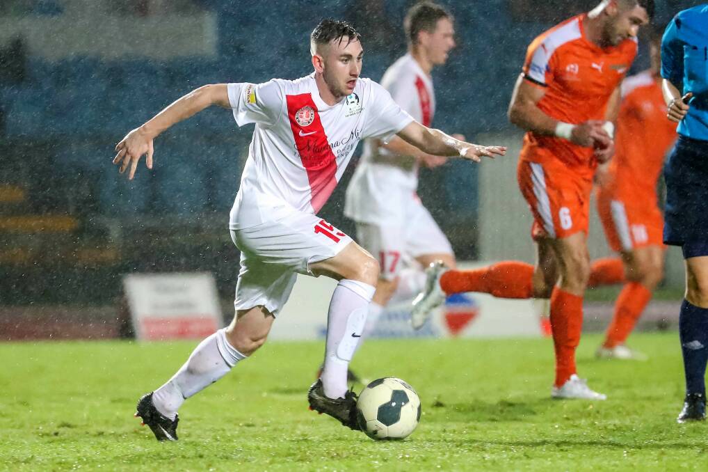 ON THE BALL: Redlands United's Mikey Dalton makes a break up the field in the wet weather.