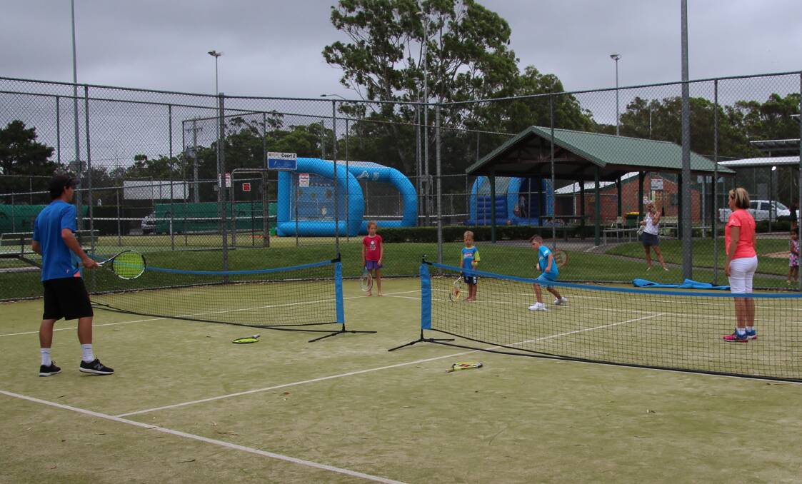 JOINING IN: The children had a lot of fun out on the court during open day, with head coach Tim Low out there with them having a hit.