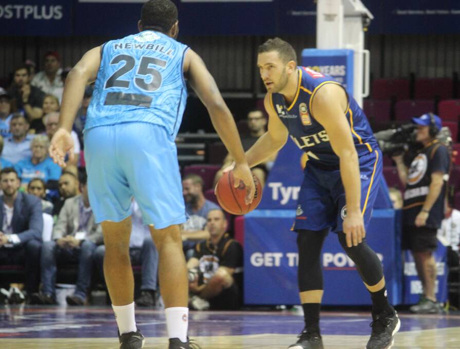 Looking ahead: Bullets guard Adam Gibson brings the ball up the court guarded by New Zealand's DJ Newbill. Photo: Joshua Paterson