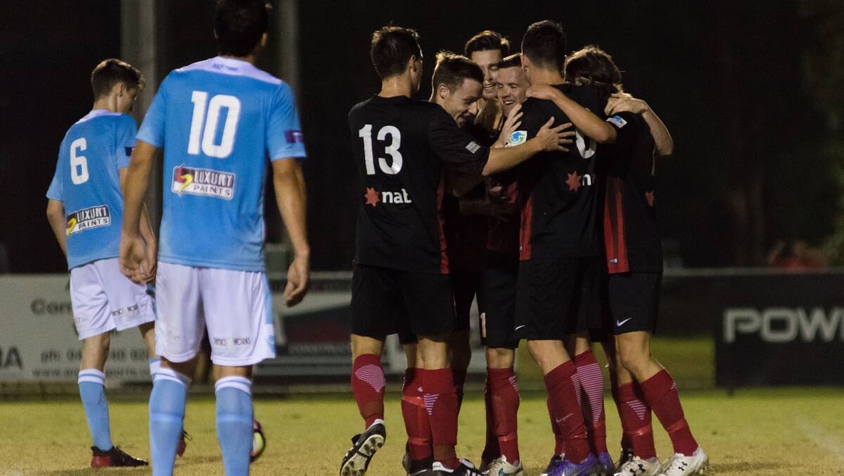 Well done: Redlands players celebrate with Graham Fyfe after his first half goal against Brisbane City. Photos by Andrew Hudson