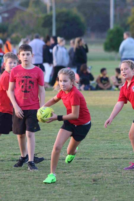 Attacking run:Jade Pelser brings the ball forward for her side in round two of Redlands Junior Touch. Photo: Supplied
