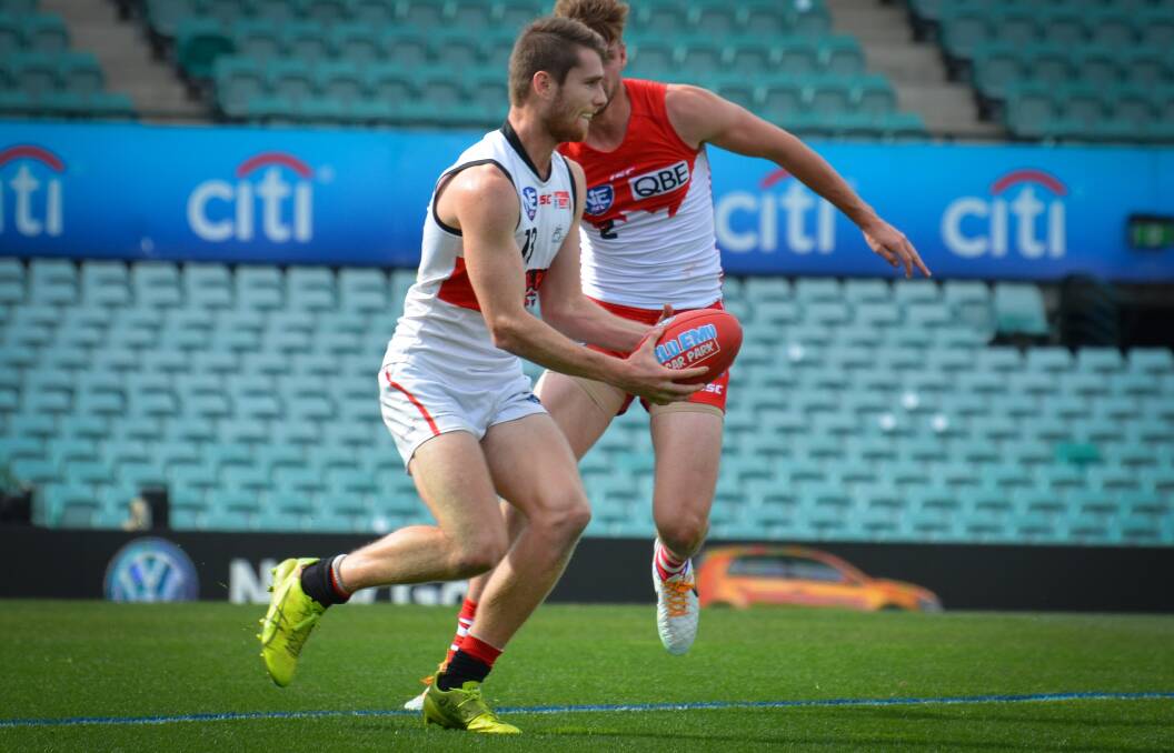 Pass: Clay Cameron looks to handball to a teammate against the Swans on the weekend. Photo: Highflyer images