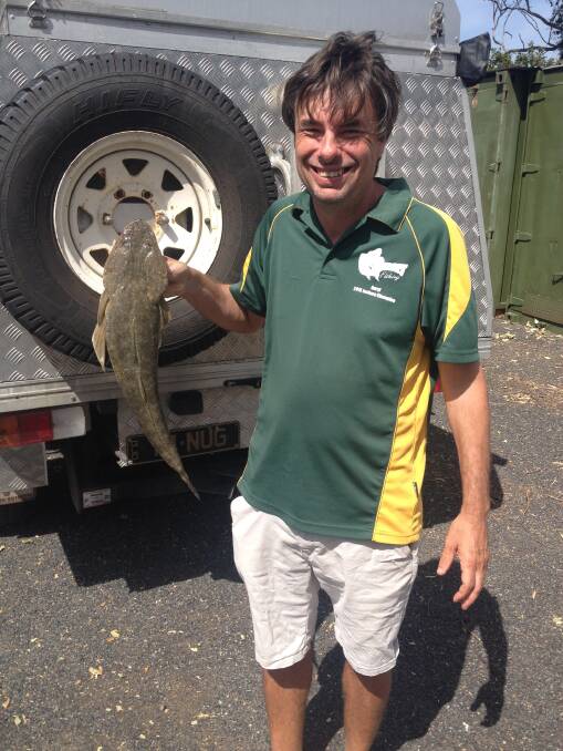 Dinner has been caught: Daryl McPhee with a pan size flathead caught from the Broadwater. Photo: Supplied