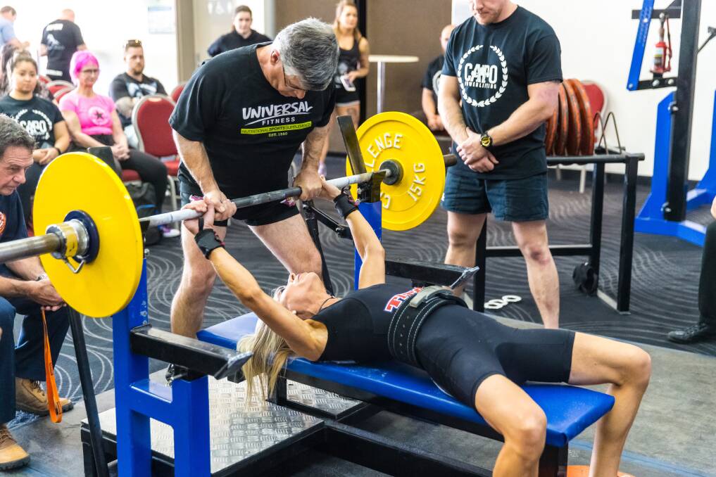 Lift: Angie Poole setting a world record in Bench Press (Angie is a mum of one of the Students that competed) she is being helped out with the bar at this year’s National Championships, by coach Kev Rogers.