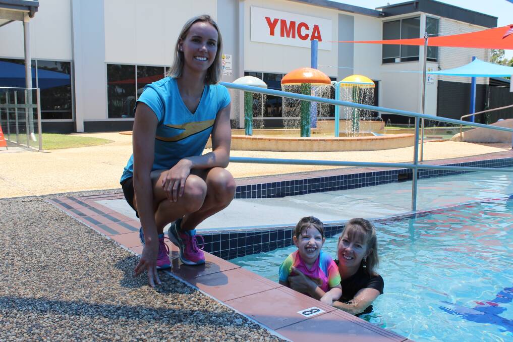 MAKING A SPLASH: Olympic Gold medallist Emma McKeon watches five-year-old Brooklyn Curry and her mother Shelly Merz make a splash at YMCA Victoria Point. Photo: Cheryl Goodenough