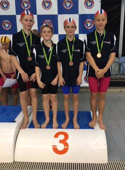 CHAMPS: The under 13 relay team on the podium having placed third in brick carry and obstacle relays. Photo: Supplied