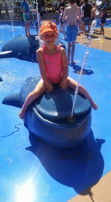 WATER PLAY: Chanel Kinley enjoys playing on the spouting whales at Wynnum over the school holidays. Her mum Hayley Cook has started a petition calling for a water play park in the Redlands. Photo: Supplied 