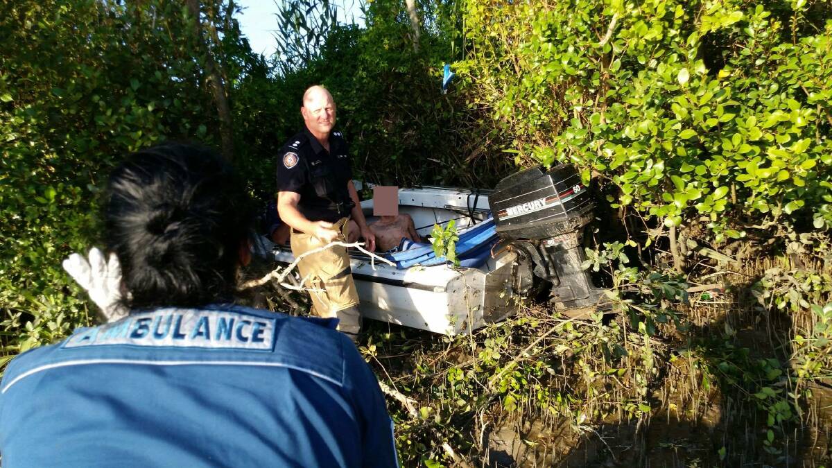 ON SCENE: Paramedics and firefighters rescue a man injured when his boat crashed on Logan River. Photo: Redland Bay Coast Guard