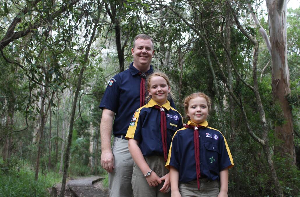 Assistant Cub Scout leader Jeff Smith, with Faith, 9, and Paige, 8, in the Eprapah Scout property at Victoria Point. Photo: Cheryl Goodenough
