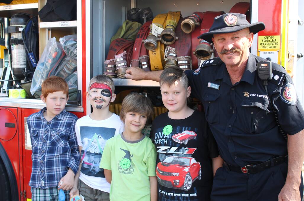 Pictured at a Vienna Woods State School event last year was firefighter Steve Ellis, of Cleveland, with Kelly, Cooper, Rhylee and Knayte. Photo: Cheryl Goodenough