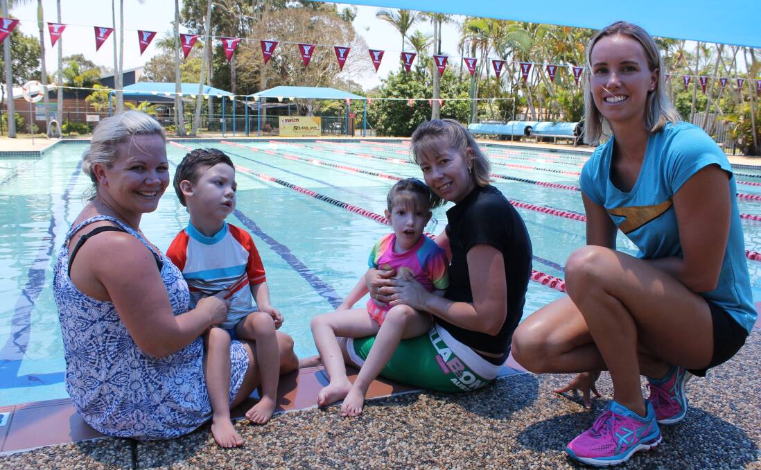 BENEFICIARIES: Olympic swimmer Emma McKeon with previous beneficiaries of money raised during the Swimathon, Tazz White, 6, with his mother Shaylee White and Brooklyn Curry, 5, with her mother Shelly Merz. Photo: Cheryl Goodenough