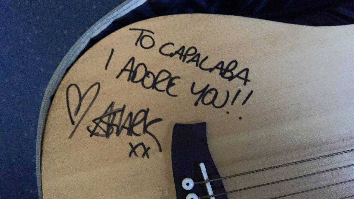 ADORE: Amy Shark signed a guitar during her visit to Capalaba State College. Photo: Supplied
