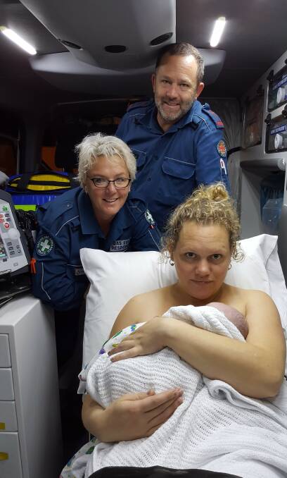 PROVIDING SUPPORT: Queensland Ambulance Service crew, Russell Island first responder Debbie Hoffman and paramedic Simon Hansson with Amy Gibson and baby Sophie in an ambulance on the mainland.