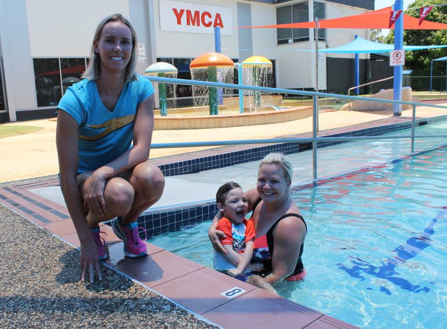ENJOYING THE WATER: Under the watchful eye of Olympic swimmer Emma McKeon are six-year-old Tazz White and his mother Shaylee at the YMCA Victoria Point. Photo: Cheryl Goodenough