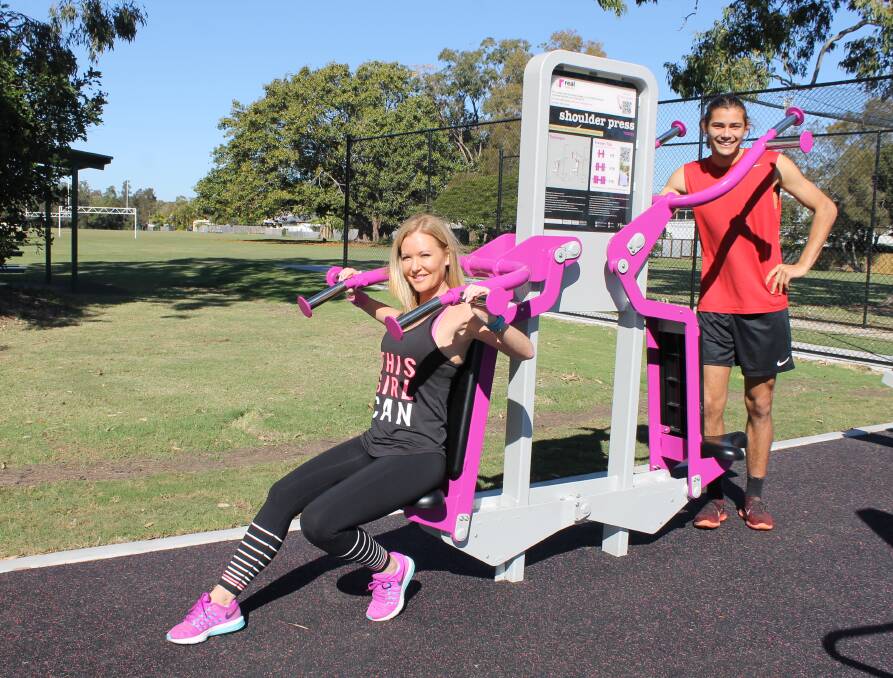 WORKING OUT: Fitness instructor Cass Blazer and Oskar Bishop at the outdoor gym in Three Paddocks Park between Birkdale and Wellington Point. Photo: Cheryl Goodenough