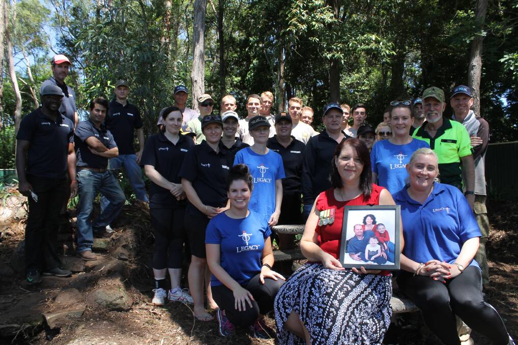 SUPPORT: Wanda Sprenger with Legacy community service officer Marlana Enkelmann and the army of supporters who transformed the backyard of her Capalaba home. Photo: Cheryl Goodenough