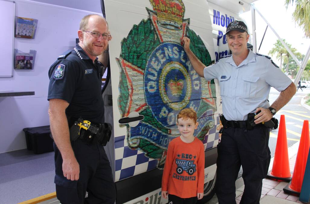 COMMUNITY POLICING: Five-year-old Liam Richards meets up with Constable Jansen Potgieter and Senior Constable Luke Taylor, both from Cleveland police station, at Victoria Point Shopping Centre. Photo: Cheryl Goodenough